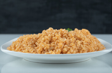 Delicious bulgur pilaf on a white plate