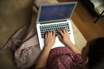 Fototapeta premium Pregnant woman sitting on floor and using laptop.