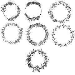Set of spring wreaths of olive branches with olives, willow branches and various plants. The technique silhouette. Wreaths with various flowers and berries. The color is black.