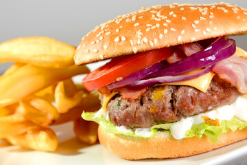 Burger with French fries cutlet with cheese and tomato