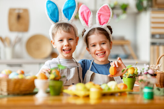 Happy easter! funny funny children   with ears hare getting ready for  holiday
