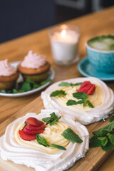 Meringue and whipped cream dessert layered with seasonal strawberry.