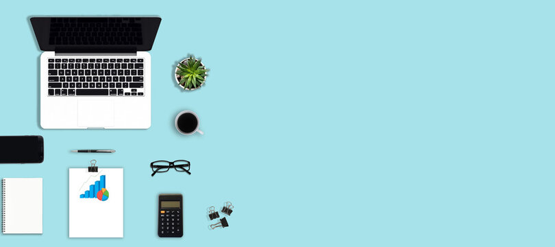 Flat lay photo of office desk with keyboard, notebook, tablet, smartphone and coffee cup, top view