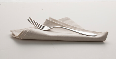 tenedor y servilleta sobre fondo  blanco. fork and napkin on white background.