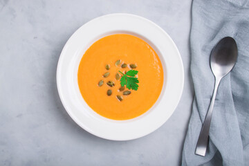 Autumn pumpkin cream soup with seeds is healthy organic vegetarian food