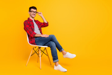 Full size profile side photo of charming young man sit chair hold wear glasses hipster isolated on...