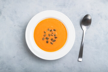 Autumn pumpkin cream soup with seeds is healthy organic vegetarian food