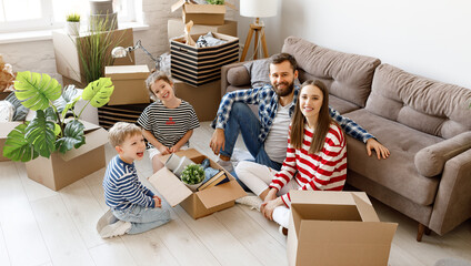 Parents and kids unpacking boxes in new apartment