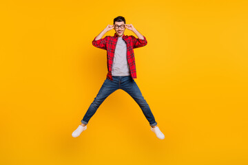 Fototapeta na wymiar Full size photo of funky positive man jump up air hold glasses star shape isolated on yellow color background