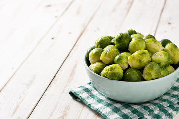 Set of brussel sprouts in a  bowl on white wooden table.Copy space