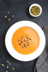 Autumn pumpkin cream soup with seeds is healthy organic vegetarian food