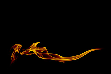Abstract orange smoke swirl trail on black background.