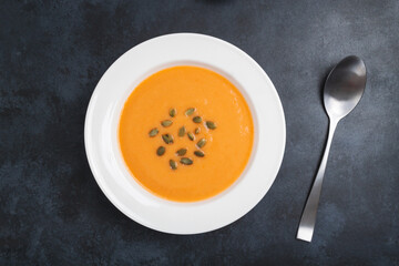 Autumn pumpkin cream soup with seeds is healthy organic vegetarian food