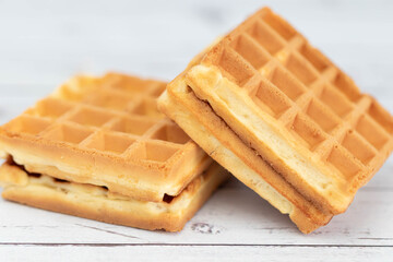 Belgian waffles close up isolated on white background. Delicious, fresh baked goods.