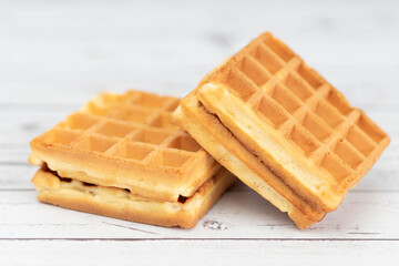 Belgian waffles close up isolated on white background. Delicious, fresh baked goods.
