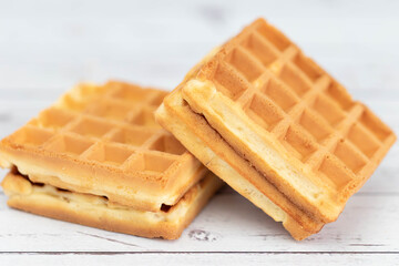 Belgian waffles close up isolated on white background. Delicious, fresh baked goods.