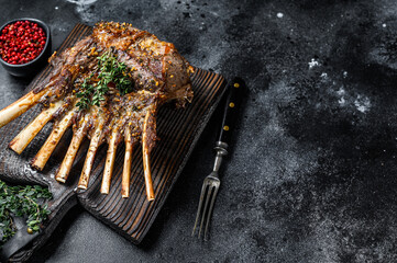 Barbecue rack of lamb meat chops. Black background. Top view. Copy space