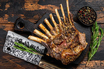 Grilled rack ribs of lamb meat chops. Dark wooden background. Top view