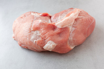 Fresh cut of pork loin on light grey kitchen table, raw  meat