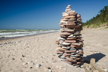 Fototapeta na wymiar Stack stones on the coast of the sea in the nature, Labrags, Latvia.