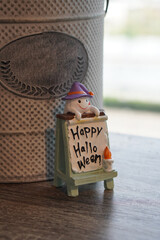 Table sign Happy Hallo Ween on wooden floor, copy space