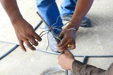 Workers are making braided wire rope for installation at the transport elevator.