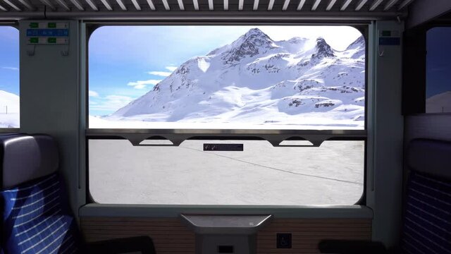 Switzerland Alps , Poschiavo - February 2021 Bernina Express, red train of Bernina pass in Ospizio Bernina station -  Unesco world heritage - Rhaetian railway with snow in a sunny day with blue sky