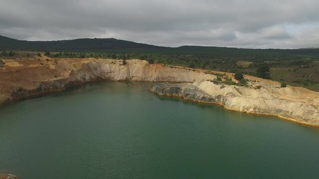 Approaching to abandoned slate mine hole with water