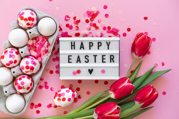 Easter eggs decorated with paper confetti and tulips