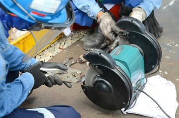 Fototapeta premium Side pic of miner worker wearing a safety glove eyes protection while using grinding wheel at the construction site