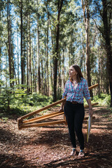 Female painter holding tripod while walking at outdoor