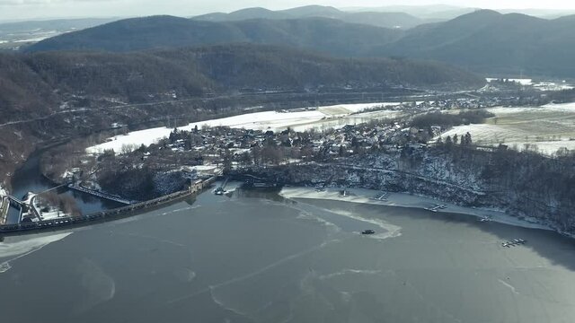 Drone Aerial views of the Keller National Park in Winter. The barrier lake Edersee is partly frozen. The Ederstausee is located in Hesse near the town Waldeck in Germany, Europe.