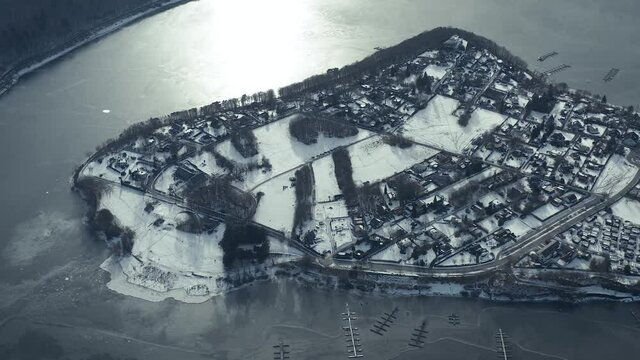 Drone Aerial views of the Keller National Park in Winter. The barrier lake Edersee is partly frozen. The Ederstausee is located in Hesse near the town Waldeck in Germany, Europe.