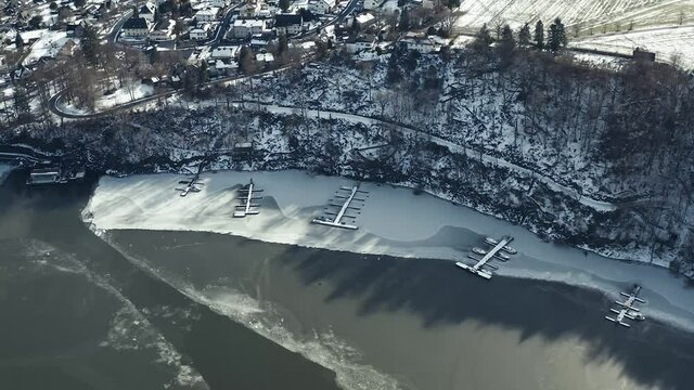 Drone Aerial views of the Keller National Park in Winter. The barrier lake Edersee is partly frozen. The Ederstausee is located in Hesse near the town Waldeck in Germany, Europe.
