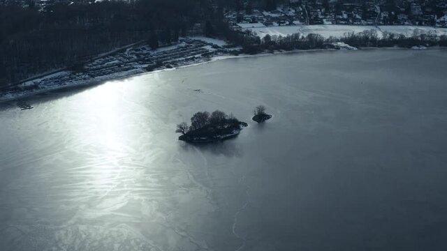 Drone Aerial views of the Keller National Park in Winter. The barrier lake Edersee is partly frozen. The Ederstausee is located in Hesse near the town Waldeck in Germany, Europe.