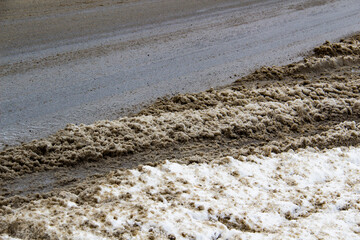 The dirty road with snow in the city Sumy in Ukraine