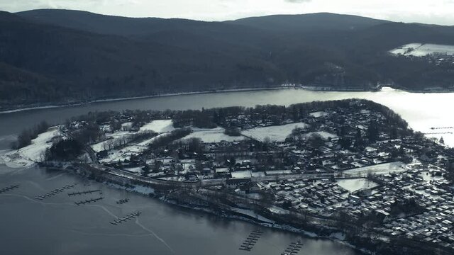 Drone Aerial views of the Keller National Park in Winter. The barrier lake Edersee is partly frozen. The Ederstausee is located in Hesse near the town Waldeck in Germany, Europe.