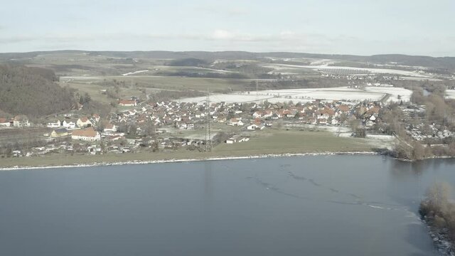 Drone Aerial views of the Keller National Park in Winter. The barrier lake Edersee is partly frozen. The Ederstausee is located in Hesse near the town Waldeck in Germany, Europe.