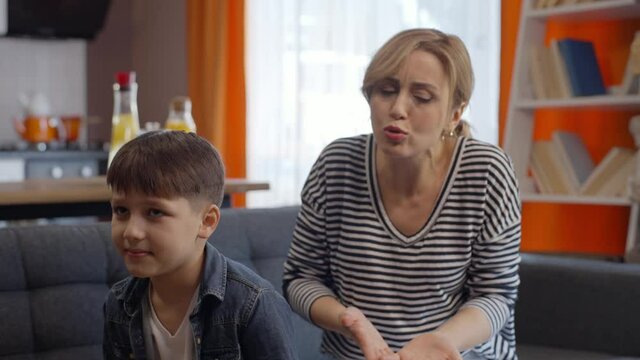 The mother who is angry with her little son who is constantly misbehaving. The little boy doesn't care about his mother. Mom and child quarrel conception. Angry mother scolding a disobedient child.