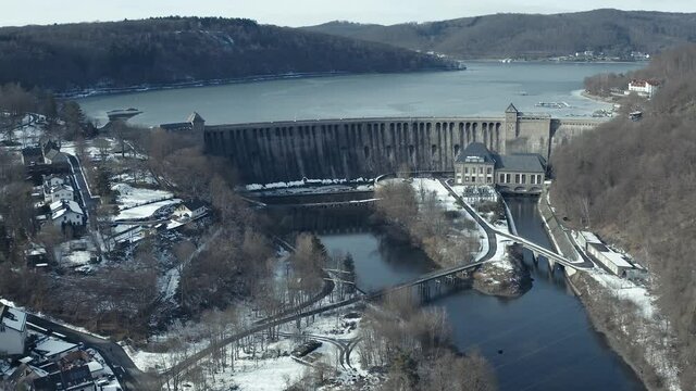 Drone Aerial views of the Keller National Park in Winter. The barrier lake Edersee is partly frozen. The Ederstausee is located in Hesse near the town Waldeck in Germany, Europe.