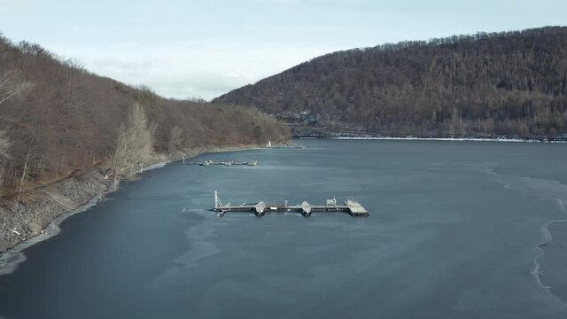 Drone Aerial views of the Keller National Park in Winter. The barrier lake Edersee is partly frozen. The Ederstausee is located in Hesse near the town Waldeck in Germany, Europe.