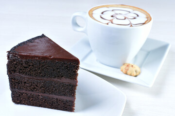 Cup of Colombian coffee, accompanied by baked cake on white wooden background
