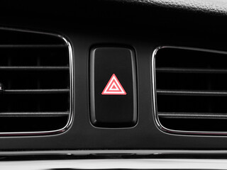 Close-up red emergency hazard light switch button in interior of modern car