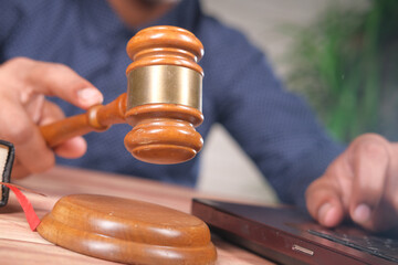 close up of person's hand striking the gavel.