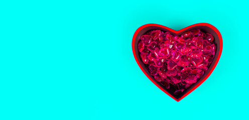 Close up of lots of hearts in red gift box in form of heart. Small red hearts in box for present on...