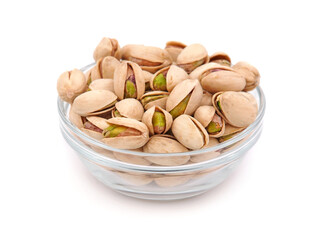 Salted pistachios in a glass bowl isolated on white
