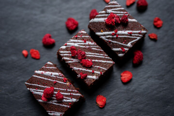selection of cute  rich dark chocolate brownies cakes  for mothersday valentines day wedding with freezedried berries
