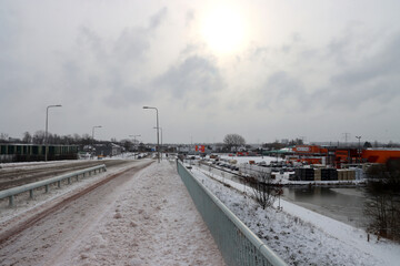 Fototapeta na wymiar Snow on the streets and frozen water during the winter of 2021 in Nieuwerkerk
