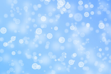 Bokeh background with happy face pattern on blue gradient colour.