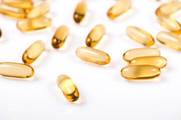 Heap of Omega 3 capsules on a white background. Top view, high resolution product. Fish fat.